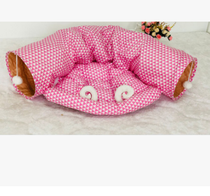 Pink geometric fabric cat tunnel bed with padded round opening and inner cushion