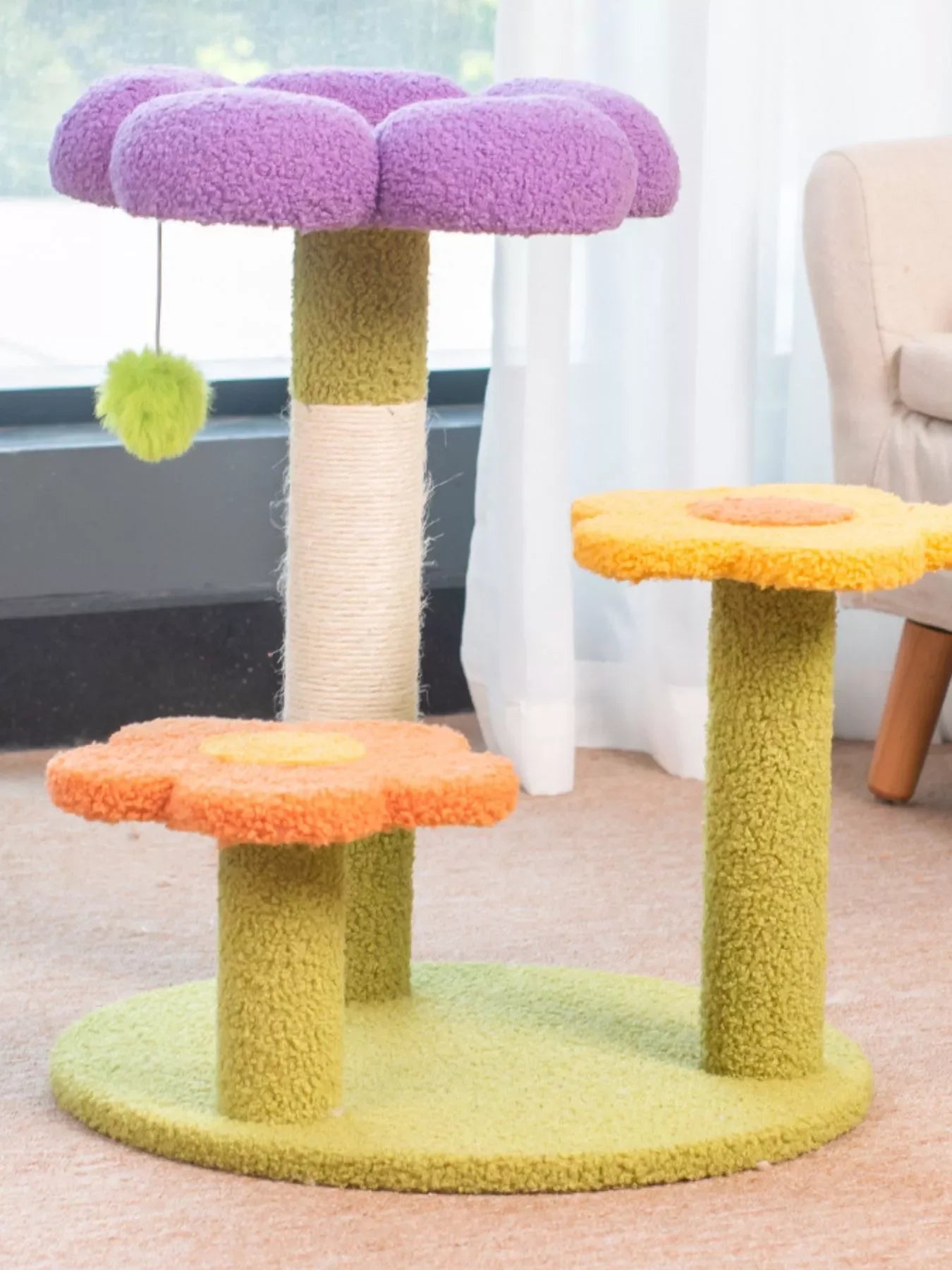 Plush cat tree with purple top perch, orange and yellow flower platforms, and green base