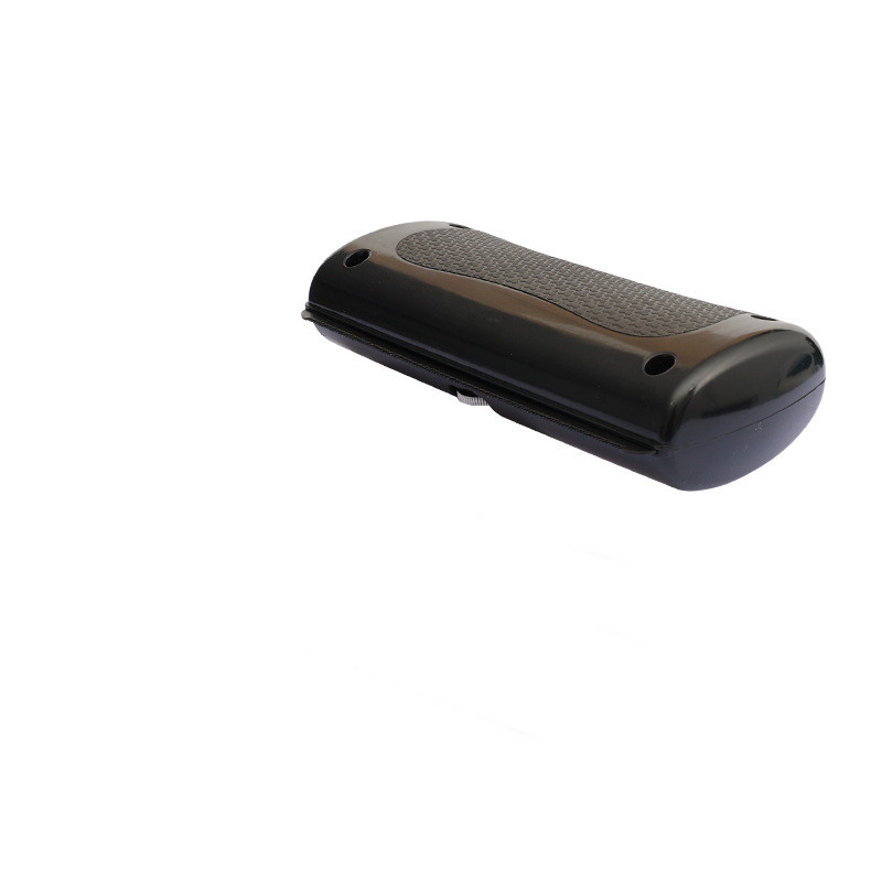 Black pet grooming comb with textured top panel and rounded casing