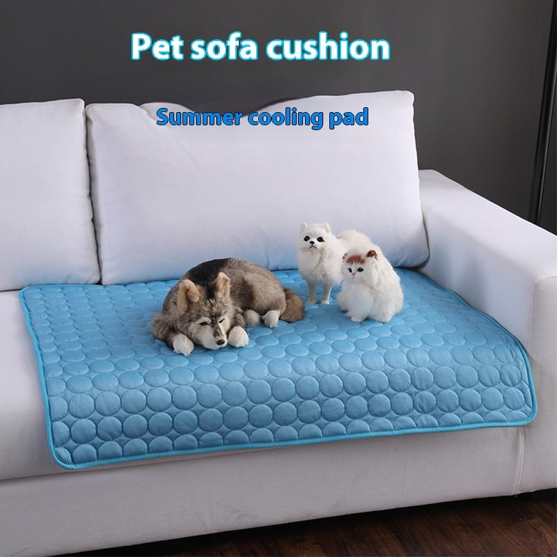 Blue cooling pet mat on a sofa cushion, with pets resting on the surface