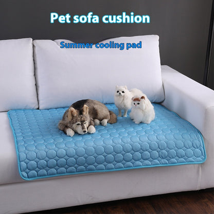 Blue cooling pet mat on a sofa cushion, with pets resting on the surface