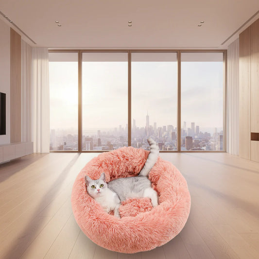 Round donut pet bed with plush pink shag outer and gray cushioned center