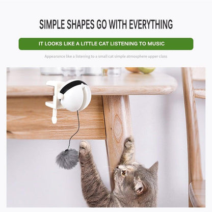 Tabletop automatic cat teaser with gray plush ball; black dome and lifting hands