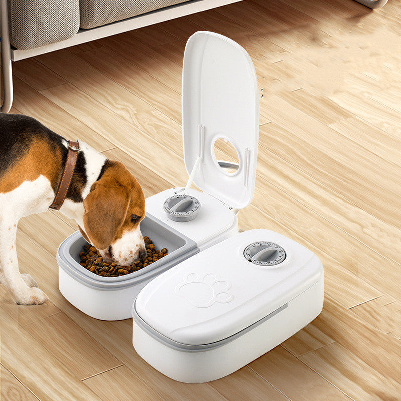 Pet feeder with open lid and white double bowls holding dry food for pets