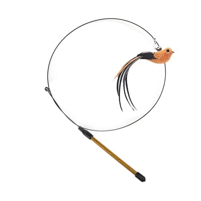 Cat teaser wand with circular ring and orange bird plush, shown on a wooden stick.