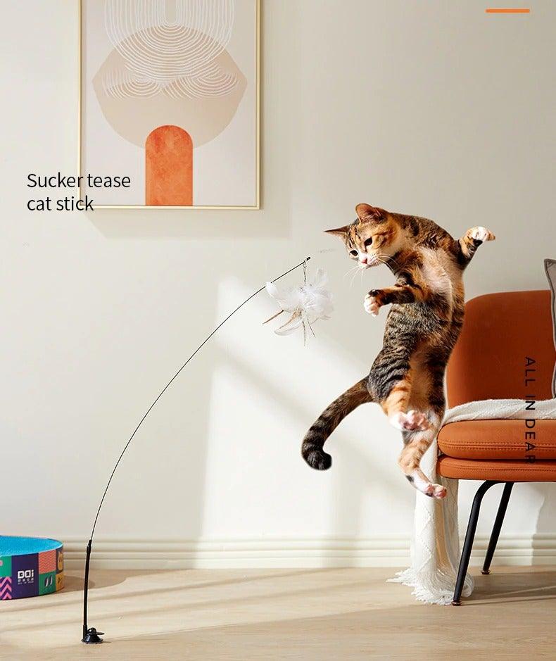 Interactive cat teaser wand with feather toy extended from a suction base