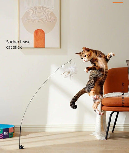 Interactive cat teaser wand with feather toy extended from a suction base
