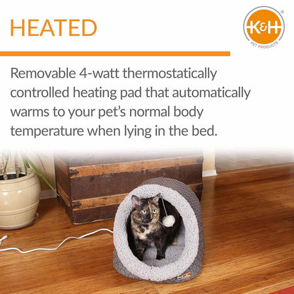 Tortoiseshell cat resting inside a plush Jeffers heated cat cave bed on a wooden floor.