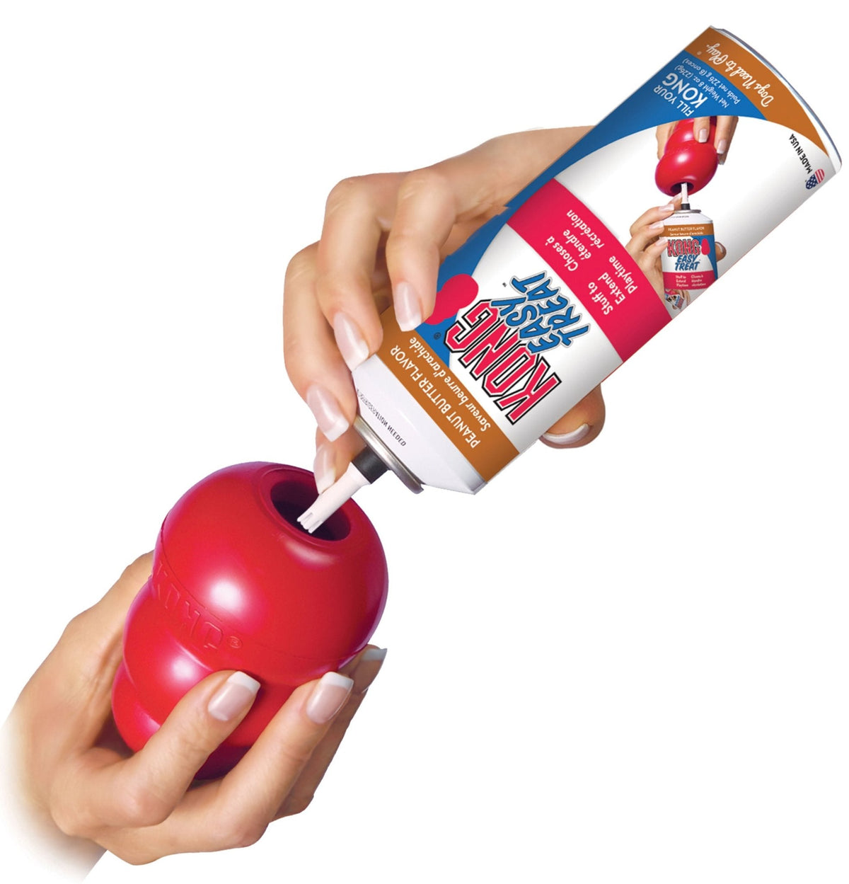 Red KONG Classic rubber dog toy held with treat tube, play prep