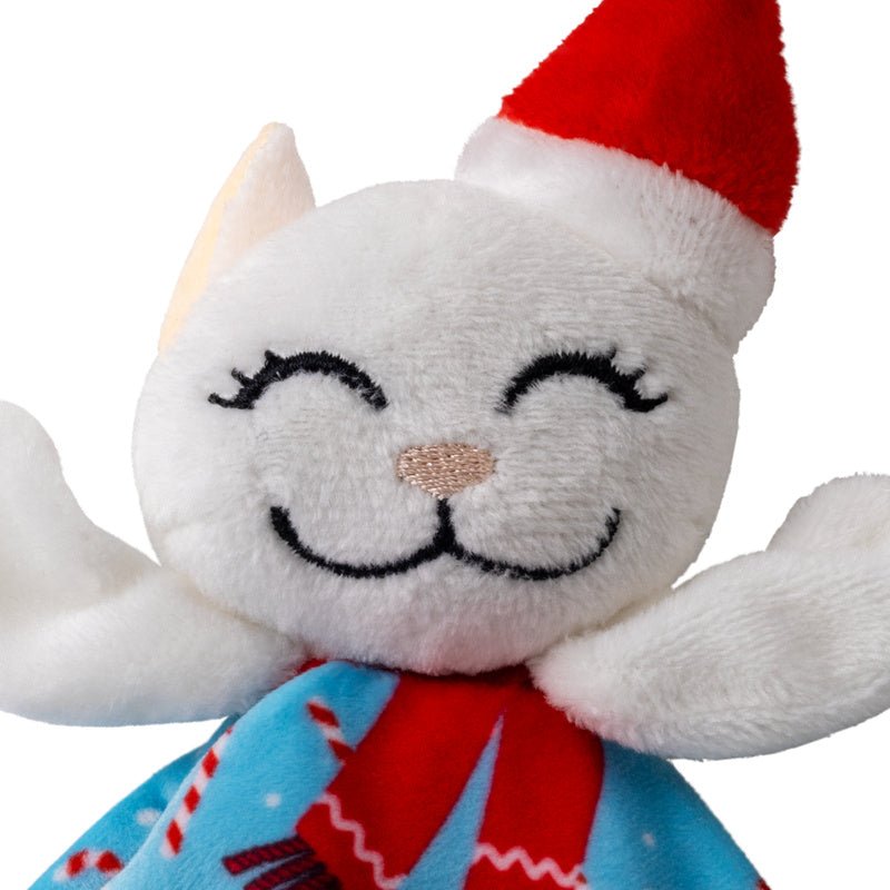 Close-up plush catnip cat face with red Santa hat, white fur, and blue patterned scarf