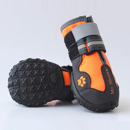 Orange and black dog waterproof bootie with paw emblem and gray strap