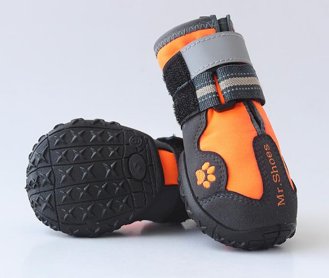 Orange and black dog waterproof booties with textured black tread soles