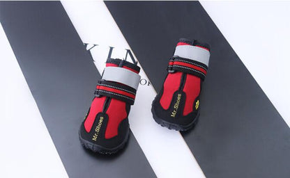 Waterproof dog boots, red lining with black uppers, white cuffs, hook straps