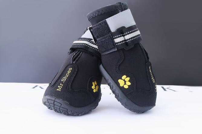 Waterproof dog boots, black with white top cuffs and yellow paw-print logos
