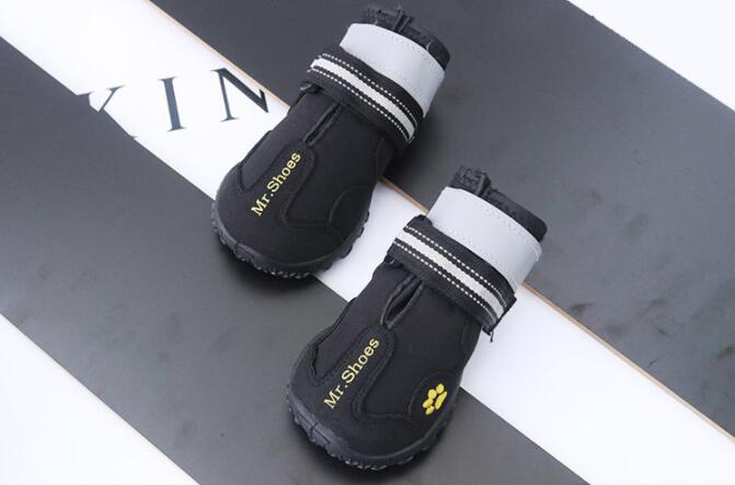 Waterproof dog boots, black with white cuffs and paw-print badge on side
