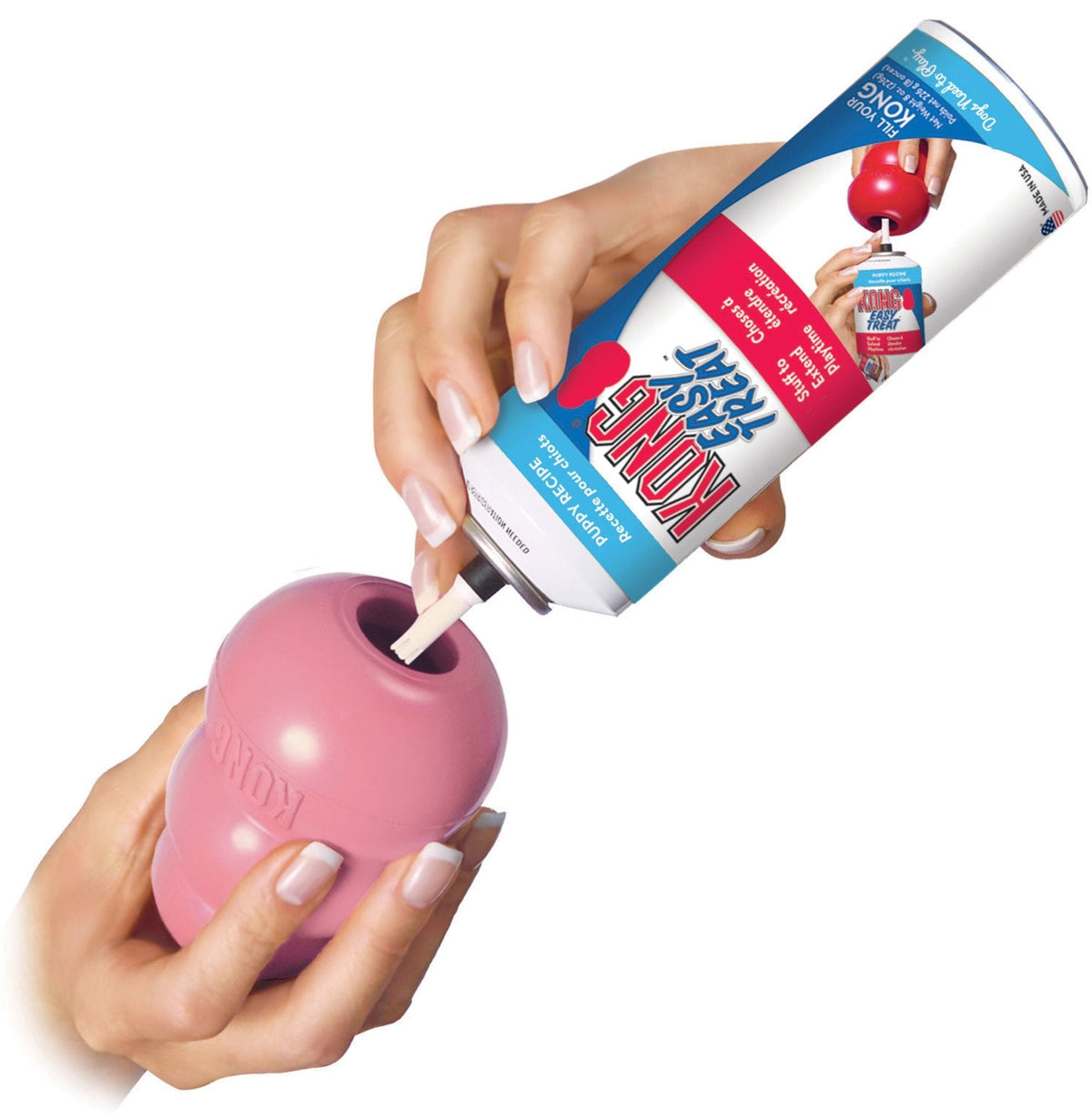 Pink KONG Puppy treat-stuffing chew toy with hands inserting a treat